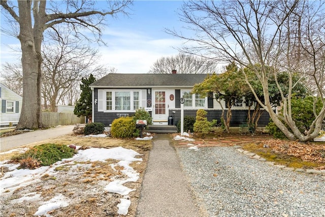 view of front of house featuring a chimney and gravel driveway