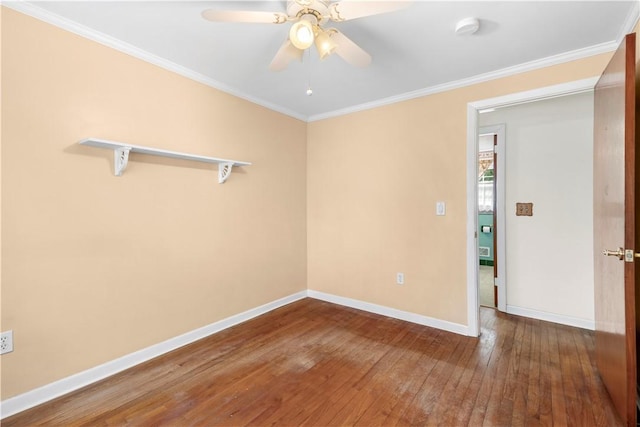 spare room with ceiling fan, crown molding, baseboards, and hardwood / wood-style flooring