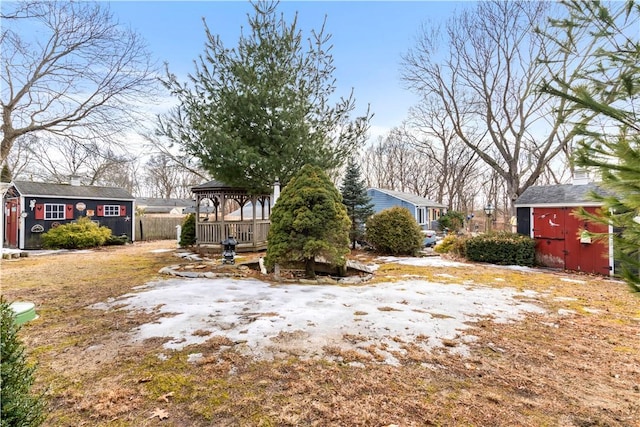 view of yard with an outbuilding, a gazebo, and a shed