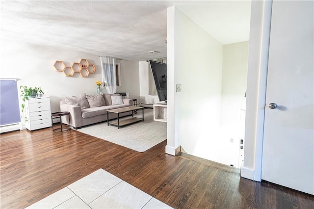 living area featuring baseboard heating and wood finished floors