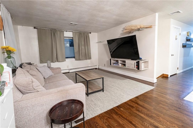 living room with a baseboard heating unit, visible vents, baseboards, and wood finished floors