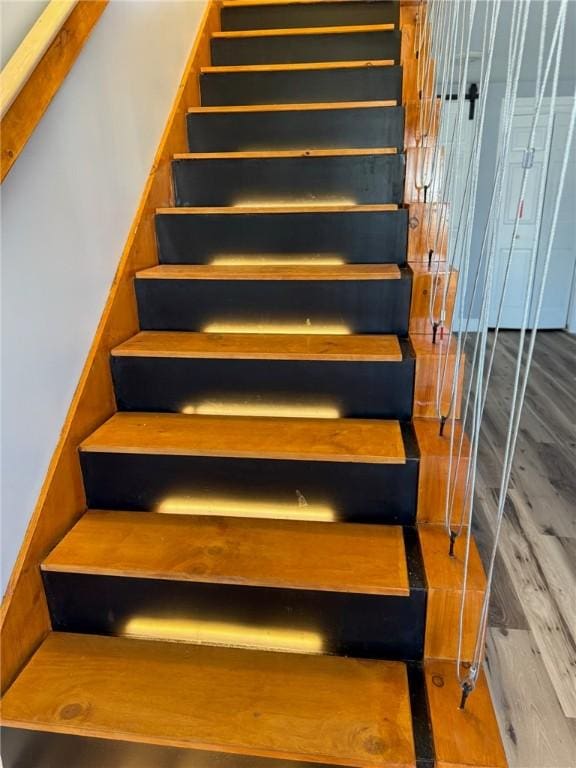 staircase with wood finished floors