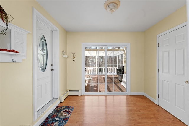 foyer featuring baseboards and wood finished floors