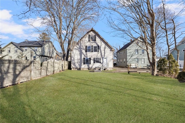 view of yard featuring fence and a residential view