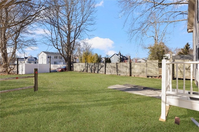 view of yard with a fenced backyard and a residential view