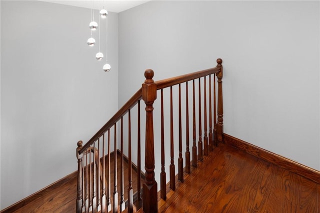 stairs featuring baseboards and wood finished floors