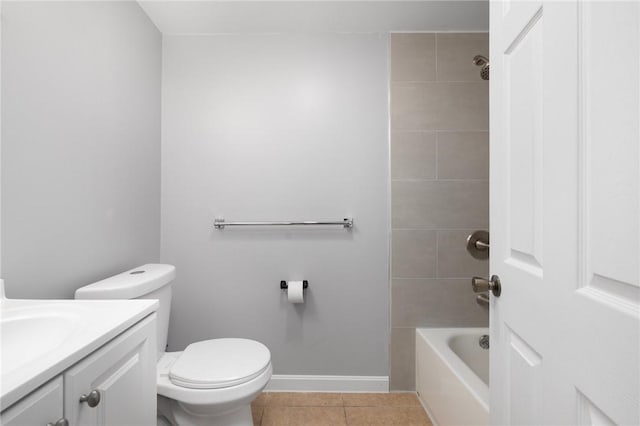 bathroom featuring baseboards, toilet, tile patterned flooring, vanity, and shower / bathing tub combination