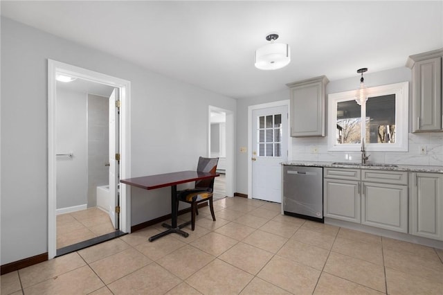 kitchen featuring dishwasher, tasteful backsplash, a sink, and gray cabinetry