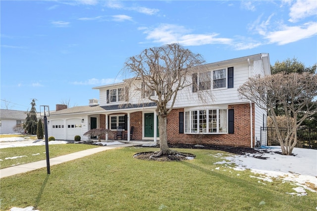 traditional-style house with an attached garage, driveway, a front lawn, and brick siding