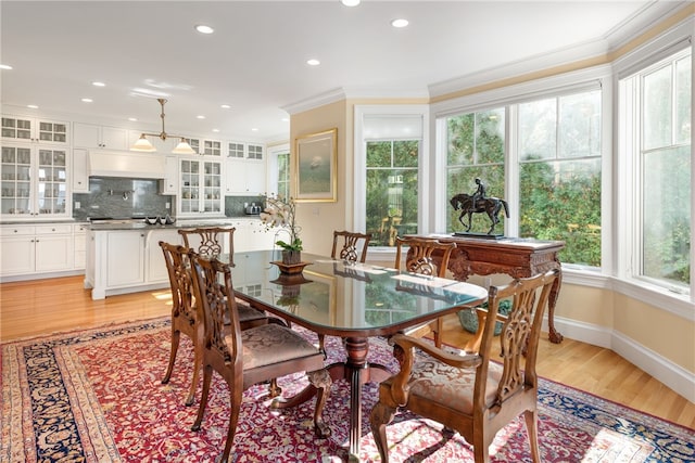 dining area with crown molding, recessed lighting, baseboards, and light wood-style floors