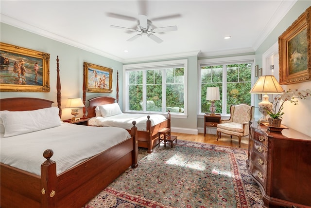 bedroom with light wood-type flooring, ceiling fan, baseboards, and crown molding