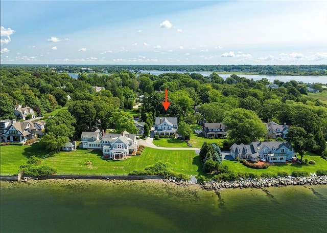 drone / aerial view featuring a water view and a view of trees