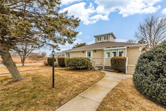 bungalow featuring entry steps and a front yard