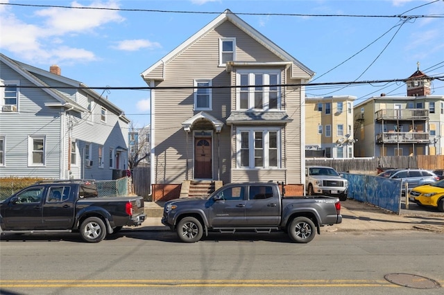 view of front of home featuring fence