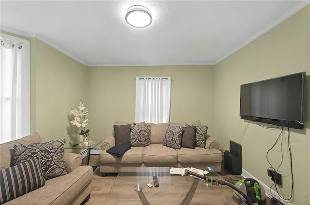 living room featuring baseboards, wood finished floors, and crown molding