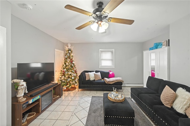 living room featuring a baseboard heating unit, a ceiling fan, and light tile patterned floors