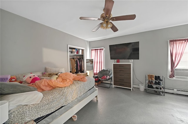 bedroom with a closet, ceiling fan, and baseboard heating