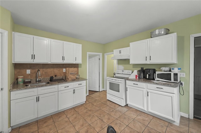 kitchen with light stone counters, a sink, decorative backsplash, white appliances, and white cabinetry
