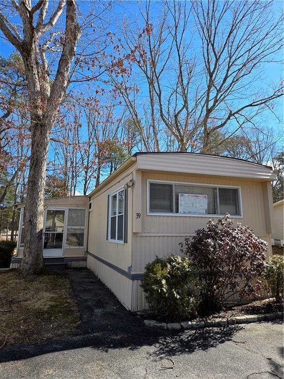 view of side of home with a sunroom