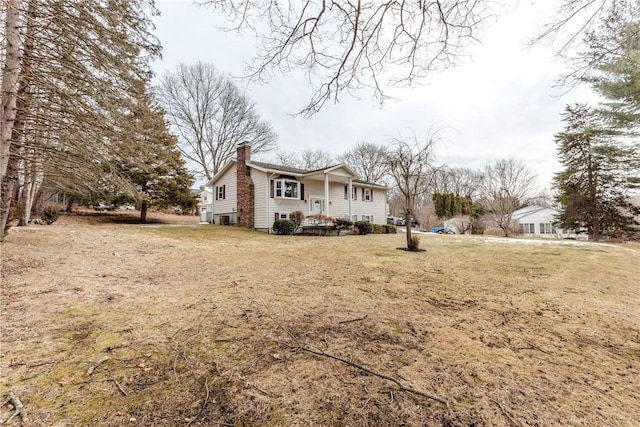 view of home's exterior featuring a yard and a chimney