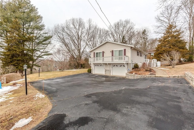 view of property exterior featuring driveway and an attached garage