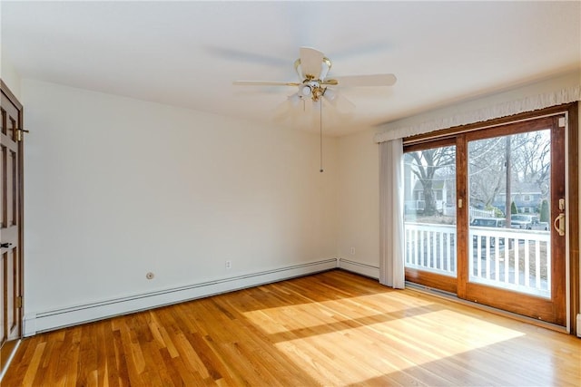 unfurnished room featuring ceiling fan, baseboard heating, and wood finished floors