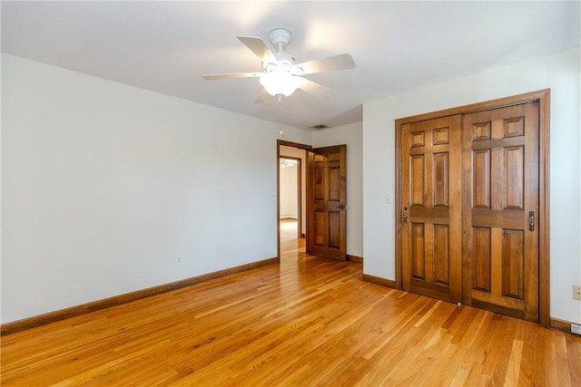 unfurnished bedroom with a ceiling fan, visible vents, baseboards, a closet, and light wood-type flooring