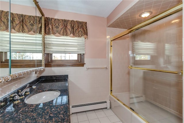 bathroom featuring a wainscoted wall, tile walls, a baseboard heating unit, vanity, and tile patterned flooring