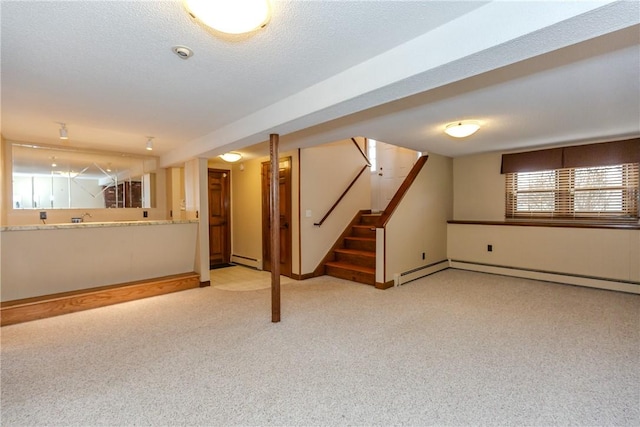 basement featuring a baseboard radiator, stairway, a textured ceiling, carpet floors, and a baseboard heating unit