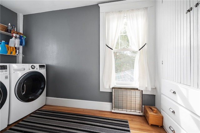 washroom featuring visible vents, separate washer and dryer, wood finished floors, laundry area, and baseboards