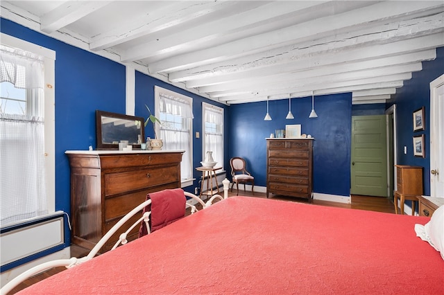 bedroom with beamed ceiling and baseboards