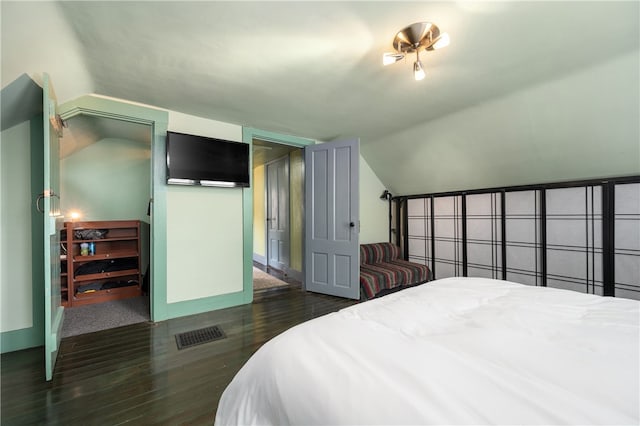 bedroom featuring vaulted ceiling and wood finished floors