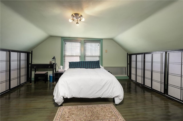 bedroom featuring dark wood-style floors and lofted ceiling