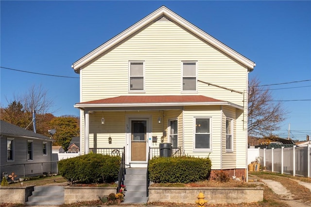 view of front of property featuring covered porch and fence