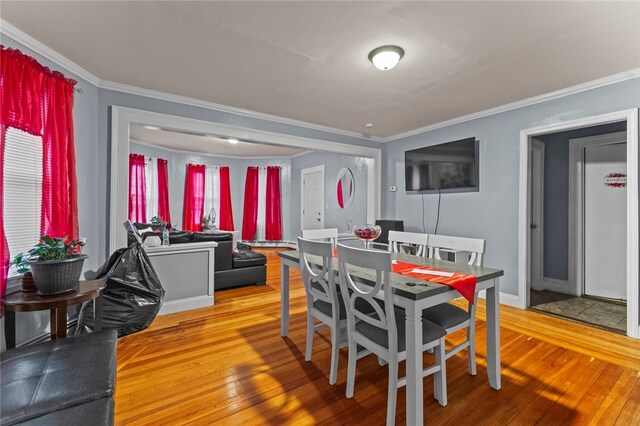 107 Lenox Ave, Providence, RI 02907 - dining area featuring light wood finished floors and ornamental molding
