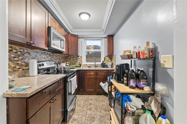 107 Lenox Ave, Providence, RI 02907 - kitchen featuring crown molding, light tile patterned floors, stainless steel appliances, decorative backsplash, and a sink