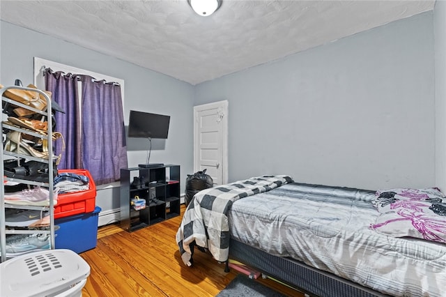 107 Lenox Ave, Providence, RI 02907 - bedroom with baseboard heating and wood finished floors