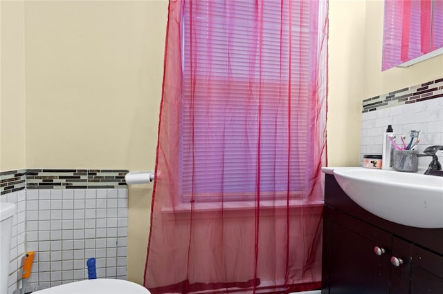 107 Lenox Ave, Providence, RI 02907 - bathroom featuring toilet, wainscoting, tile walls, and vanity