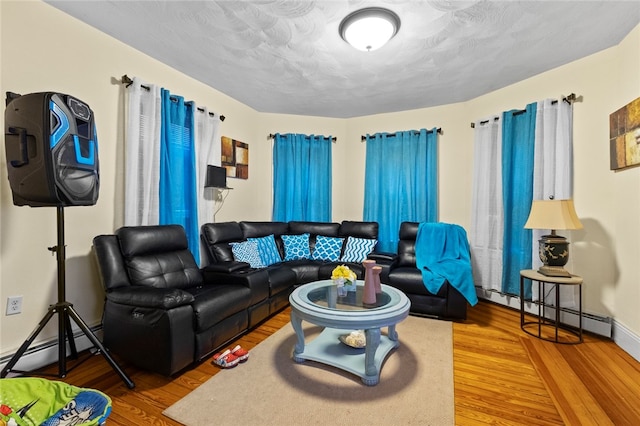 107 Lenox Ave, Providence, RI 02907 - living area with a textured ceiling, baseboard heating, and wood finished floors
