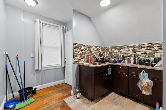 107 Lenox Ave, Providence, RI 02907 - kitchen with light countertops, tasteful backsplash, dark brown cabinetry, and light wood-style floors