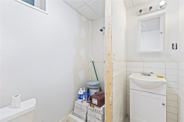 107 Lenox Ave, Providence, RI 02907 - bathroom with tile walls, a drop ceiling, vanity, and toilet