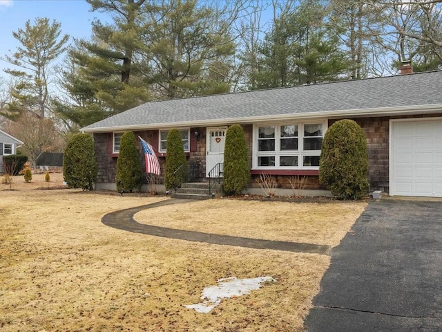 ranch-style house with a garage, roof with shingles, a chimney, and aphalt driveway