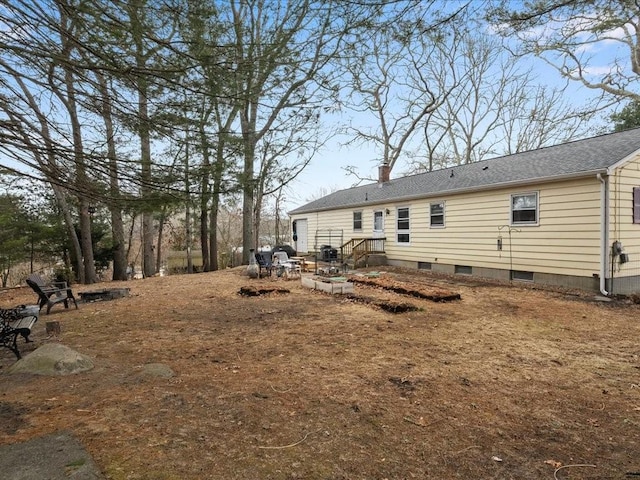 rear view of property featuring a chimney