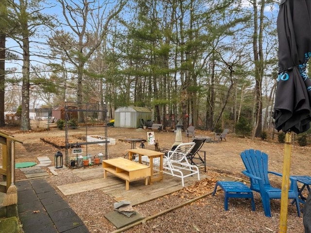 view of patio with a shed and an outdoor structure