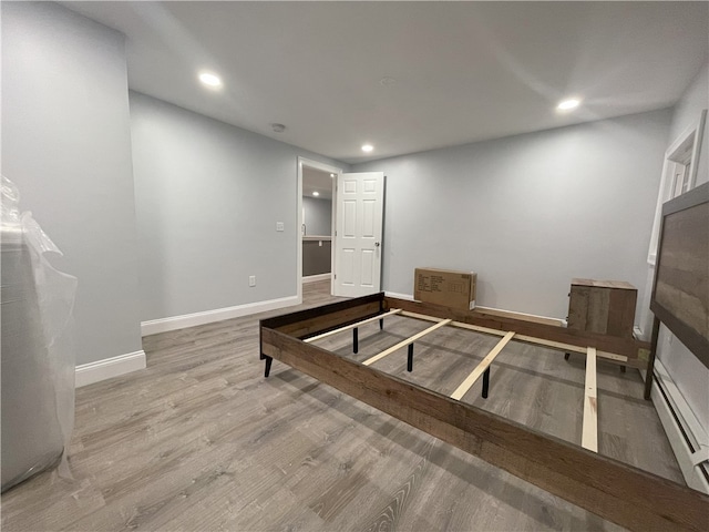 interior space featuring baseboards, wood finished floors, and recessed lighting