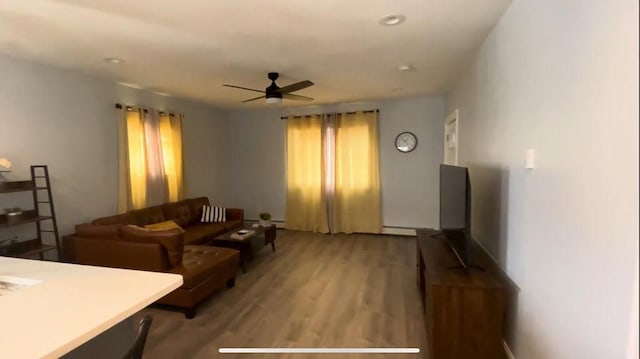 living room with wood finished floors and a ceiling fan