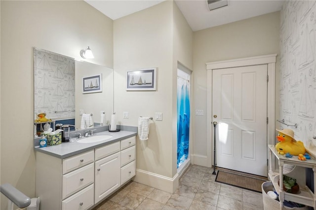 bathroom featuring a shower with curtain, baseboards, and vanity