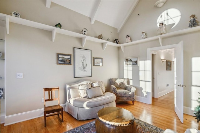 living area with baseboards, high vaulted ceiling, beam ceiling, and wood finished floors