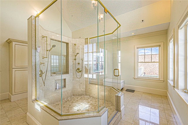 bathroom with lofted ceiling, a stall shower, baseboards, and a textured ceiling