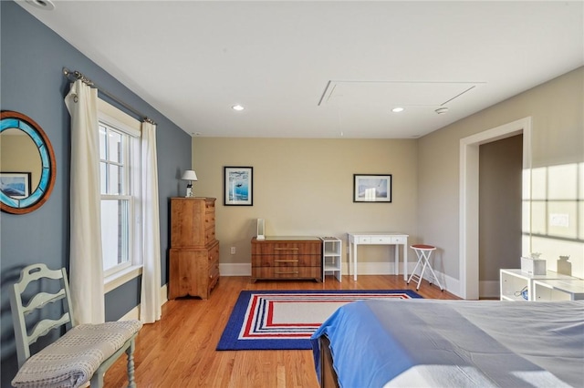 bedroom with recessed lighting, wood finished floors, attic access, and baseboards